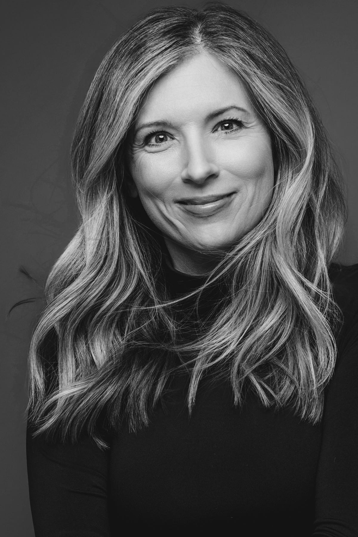 Black-and-white editorial portrait of Jennifer Renee Johnson, founder and lead photographer of J Renee Studios — modern boudoir, portrait, and branding photography in Boise and Las Vegas