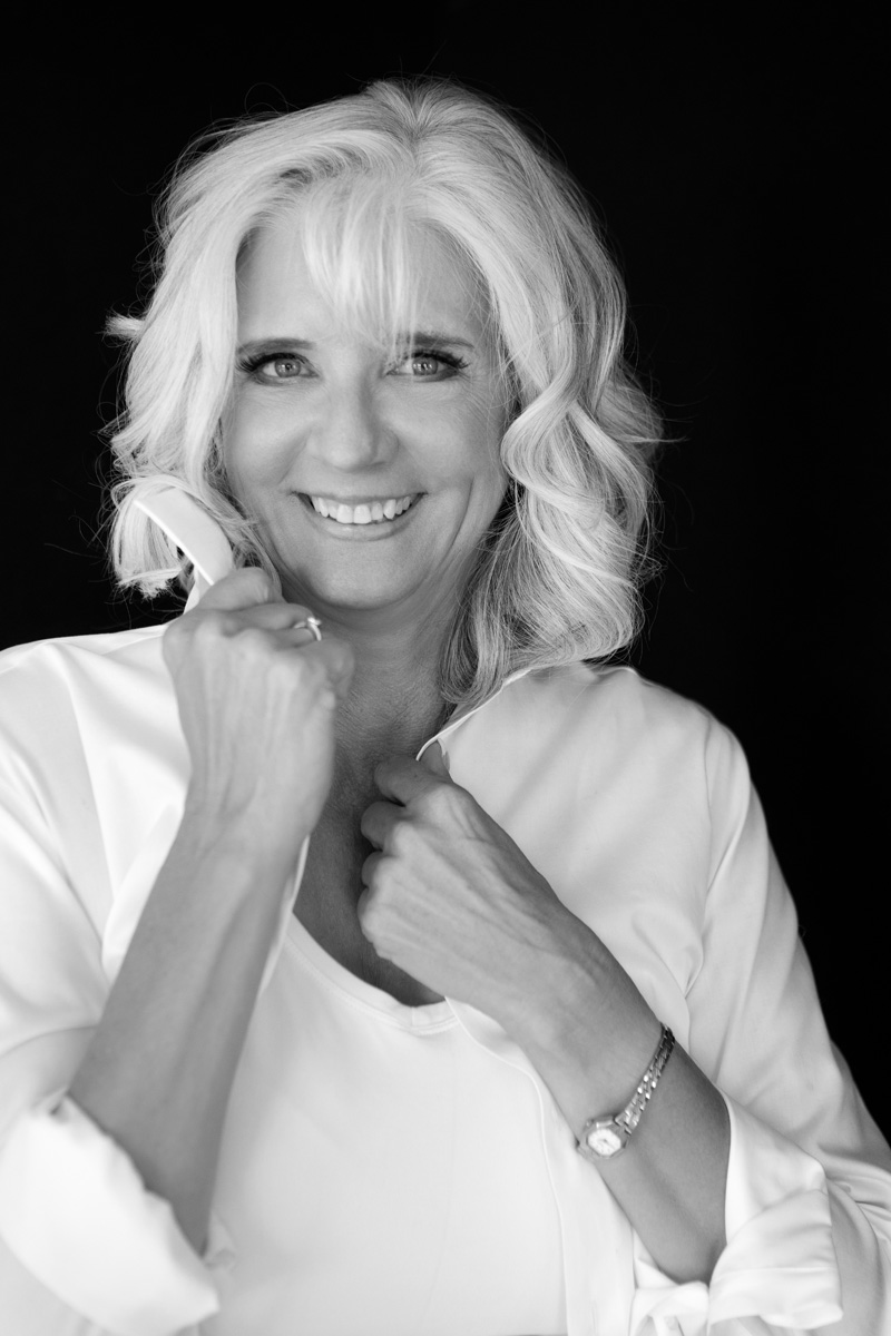 Boise modern portraits — joyful black and white portrait of a woman in a white blouse